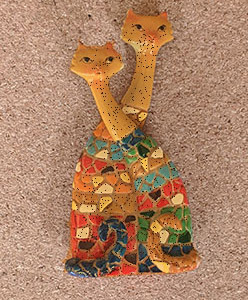 a small toy of two mosaic cats, one sitting slightly in front of the other